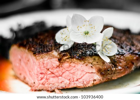Closeup photo of fresh meat stake with flower on it