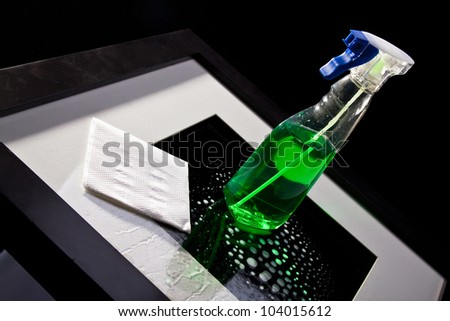 Photo of paper napkin and cleaning agent on a frame
