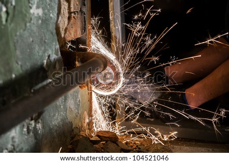 Photo of spinnig circular saw with bunch of sparks