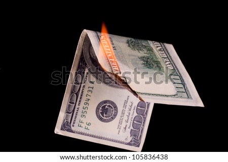 Closeup photo of burning dollar banknote on black background