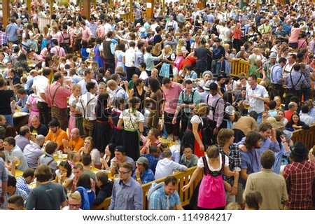 MUNICH, GERMANY - OCT 3: beer tent with dancing people at world biggest beer festival \