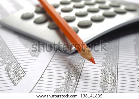 finance calculator and red pencil on business calculation