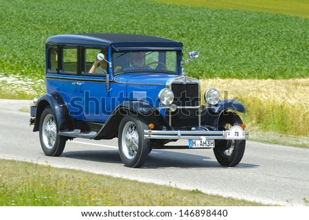 LANDSBERG, GERMANY - JULY 13: Oldtimer rallye for at least 80 years old antique cars with Chevrolet Sedan AD Universal, built at year 1930, photo taken on July 13, 2013 in Landsberg, Germany