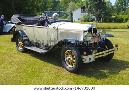 LANDSBERG, GERMANY - JULY 13: Oldtimer rallye for at least 80 years old antique cars with Pontiac open Tourer, built at year 1929, photo taken on July 13, 2013 in Landsberg, Germany