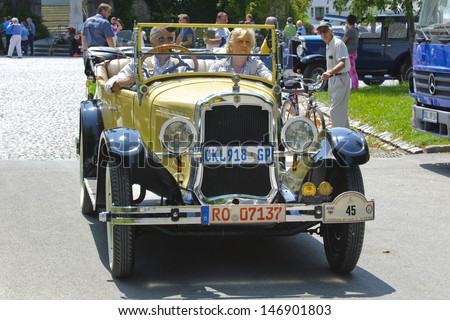 LANDSBERG, GERMANY - JULY 12: Oldtimer rallye for at least 80 years old antique cars with Oldsmobile, built at year 1924, photo taken on July 12, 2013 in Landsberg, Germany