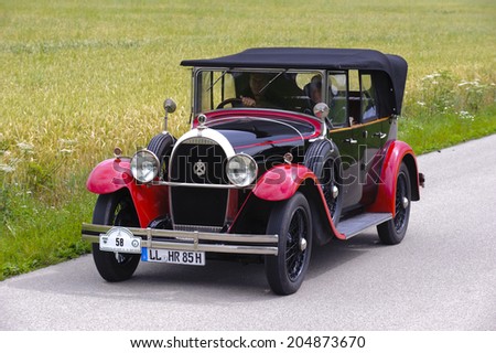 LANDSBERG, GERMANY - JULY 12, 2014: Public oldtimer rally organized by Bavarian city Landsberg for at least 80 years old veteran cars with unknown drivers in Hotchkiss open Tourer, built at year 1928