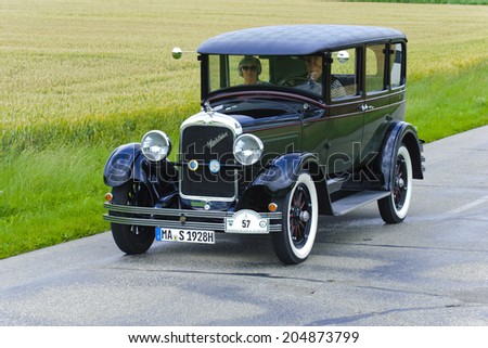 LANDSBERG, GERMANY - JULY 12, 2014: Public oldtimer rally organized by Bavarian city Landsberg for at least 80 years old veteran cars with unknown drivers in Studebaker Sedan, built at year 1928