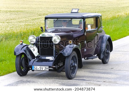 LANDSBERG, GERMANY - JULY 12, 2014: Public oldtimer rally organized by Bavarian city Landsberg for at least 80 years old veteran cars with unknown drivers in Sunbeam 16 HP, built at year 1930.
