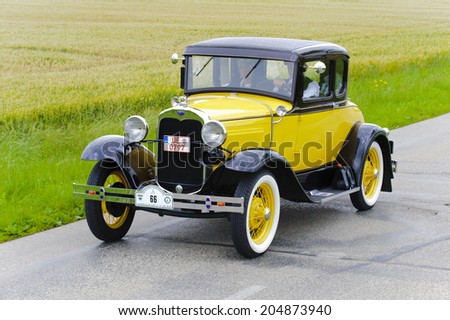 LANDSBERG, GERMANY - JULY 12, 2014: Public oldtimer rally organized by Bavarian city Landsberg for at least 80 years old veteran cars with unknown drivers in Ford A Coupe, built at year 1930