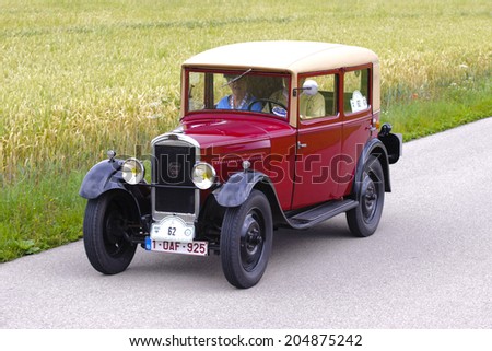 LANDSBERG, GERMANY - JULY 12, 2014: Public oldtimer rally organized by Bavarian city Landsberg for at least 80 years old veteran cars with unknown drivers in Peugeot 201, built at year 1929