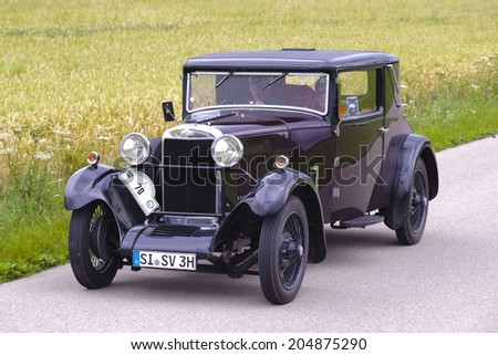 LANDSBERG, GERMANY - JULY 12, 2014: Public oldtimer rally organized by Bavarian city Landsberg for at least 80 years old veteran cars with unknown drivers in Sunbeam 16 HP, built at year 1930