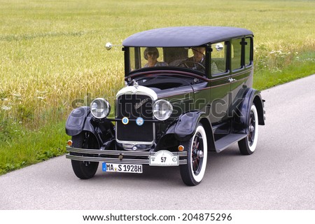 LANDSBERG, GERMANY - JULY 12, 2014: Public oldtimer rally organized by Bavarian city Landsberg for at least 80 years old veteran cars with unknown drivers in Studebaker Sedan, built at year 1928