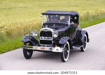 LANDSBERG, GERMANY - JULY 12, 2014: Public oldtimer rally organized by Bavarian city Landsberg for at least 80 years old veteran cars with unknown drivers in Ford A, built at year 1928