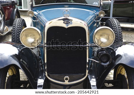 LANDSBERG, GERMANY - JULY 12, 2014: Public oldtimer rally in Bavarian city Landsberg for at least 80 years old veteran cars with a front view of Ford Tourer