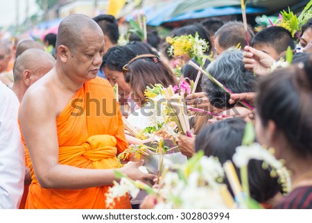 Saraburi,Thailand - July 31 : People giving flower alms to buddhist monks in annual festival of flower alm to buddhist on 31 July 2015