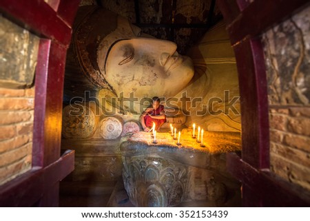 BAGAN,MYANMAR - FEBUARY , 1 : Monk in meditation inside temple at big white reclining buddha image near shwesandow pagoda in Bagan Mandalay Myanmar 1 FEBUARY 2014