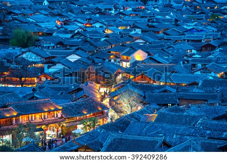 Lijiang Old Town bird eye top top view with local historical architectures roof building in night scene