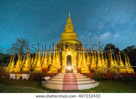 Beautiful golden pagoda of Pa sawangboon temple with milky way and star at night scene