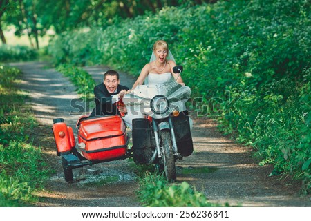 Bride and groom riding on an old bike