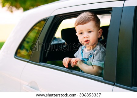 Adorable baby boy in the car