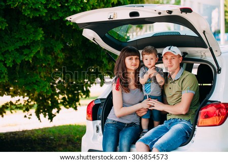 Happy family sitting in the car