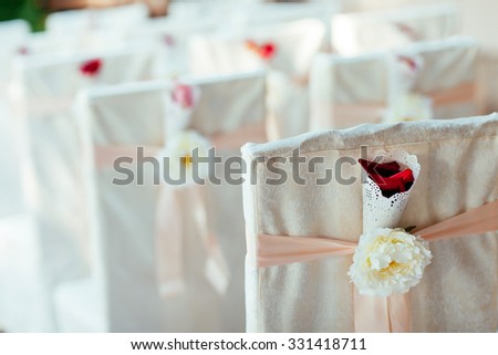 Wedding ceremony chairs. Floral arrangement at a wedding ceremony.