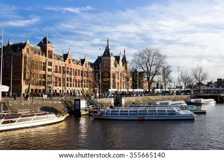 Amsterdam,Netherlands â?? December 23, 2015 : Amsterdam sightseeing boat tour with Amsterdam central in blackground