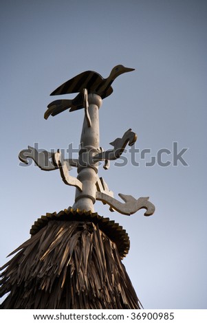 old style weather vane with a bird figure