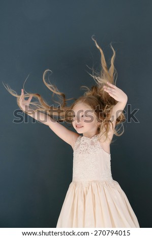 Cute little girl toss up her hairs and smiling