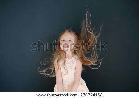 Cute little girl toss up her hairs