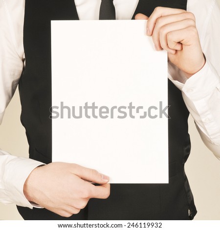 business man holding a poster. place for text. template for text