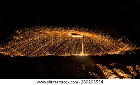 Abstract Image of Burning Wirewool being used to make circle like light trails at Night