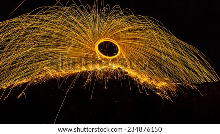 Abstract Image of Burning Wirewool being used to make circle like light trails at Night