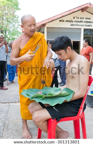 NAKHON RATCHASIMA,THAILAND MAY 10 : Male who will be monk cut hair for be Ordained. Thailand on May 10, 2015