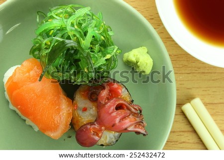 salmon sushi seaweed sushi and squid sushi with wasabi and shoyu sauce