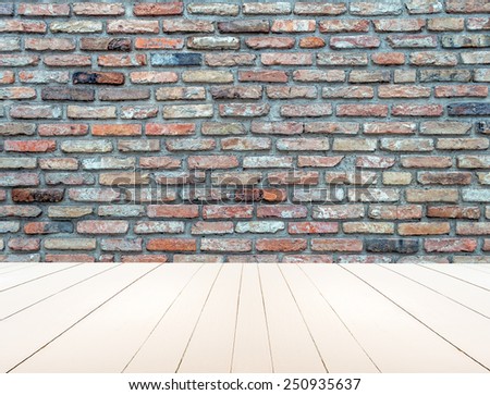 Textured old brick wall with white wooden floor inside