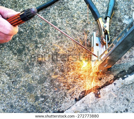 Hard work, welding torch and sparks