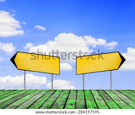 Two street signs with beautiful blue sky with cloud closeup and green wooden floor