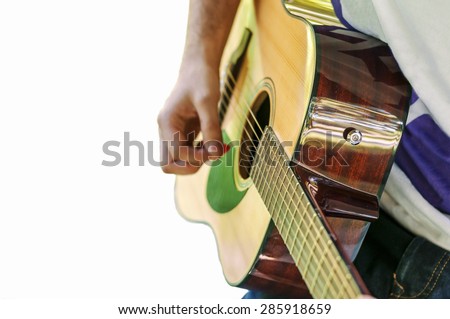 Young guitar player playing song outdoor isolated on white