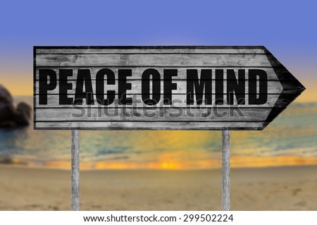 Peace of Mind wooden sign with beach background
