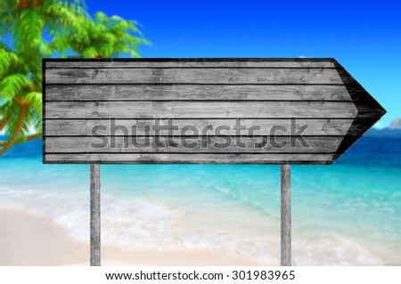 Empty wooden sign with a beach on background