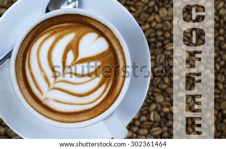 Cup of hot espresso drink on left with coffee bean background and written word COFFEE