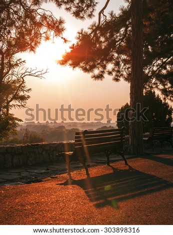 Colorful sunset scenery on castle path with a bench