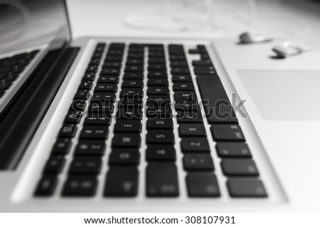 Top view of the keyboard of the laptop on Desk with headphones close