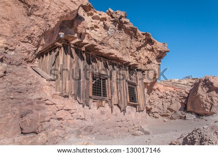 Old West Mining Shack in the California Desert under a bright blue sky