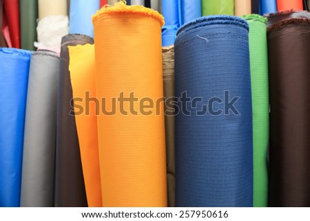 Colorful fabric rolls , focus on front fabric