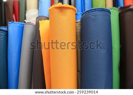 Colorful fabric rolls. Focus on front part of rolls.