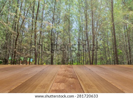 wooden floor texture with green pine forest  background