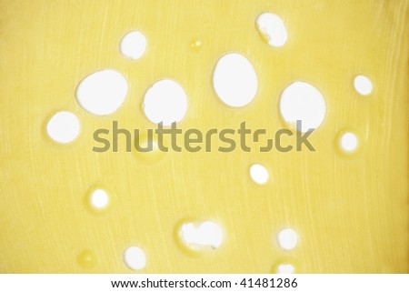 Piece yellow with holes cheese as a background