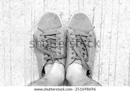 old Canvas shoes  walking on floor top view grey